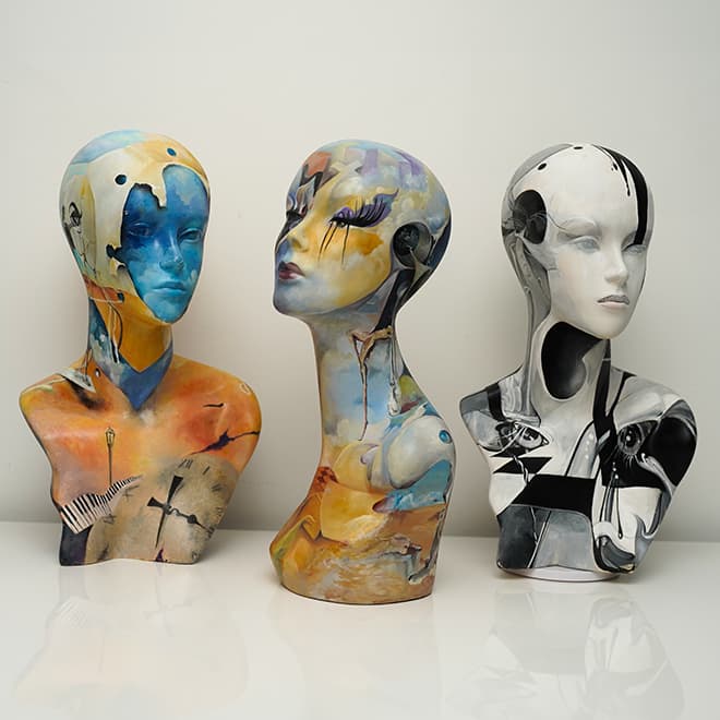 Three uniquely painted busts side by side, each representing a different aspect of consciousness or emotion. One features cool tones and geometric patterns, another warm hues and organic shapes, and the third a monochromatic scheme with bold contrasts. Together, they symbolize the complexity of human cognition and expression.",
"title": "Trio of Consciousness